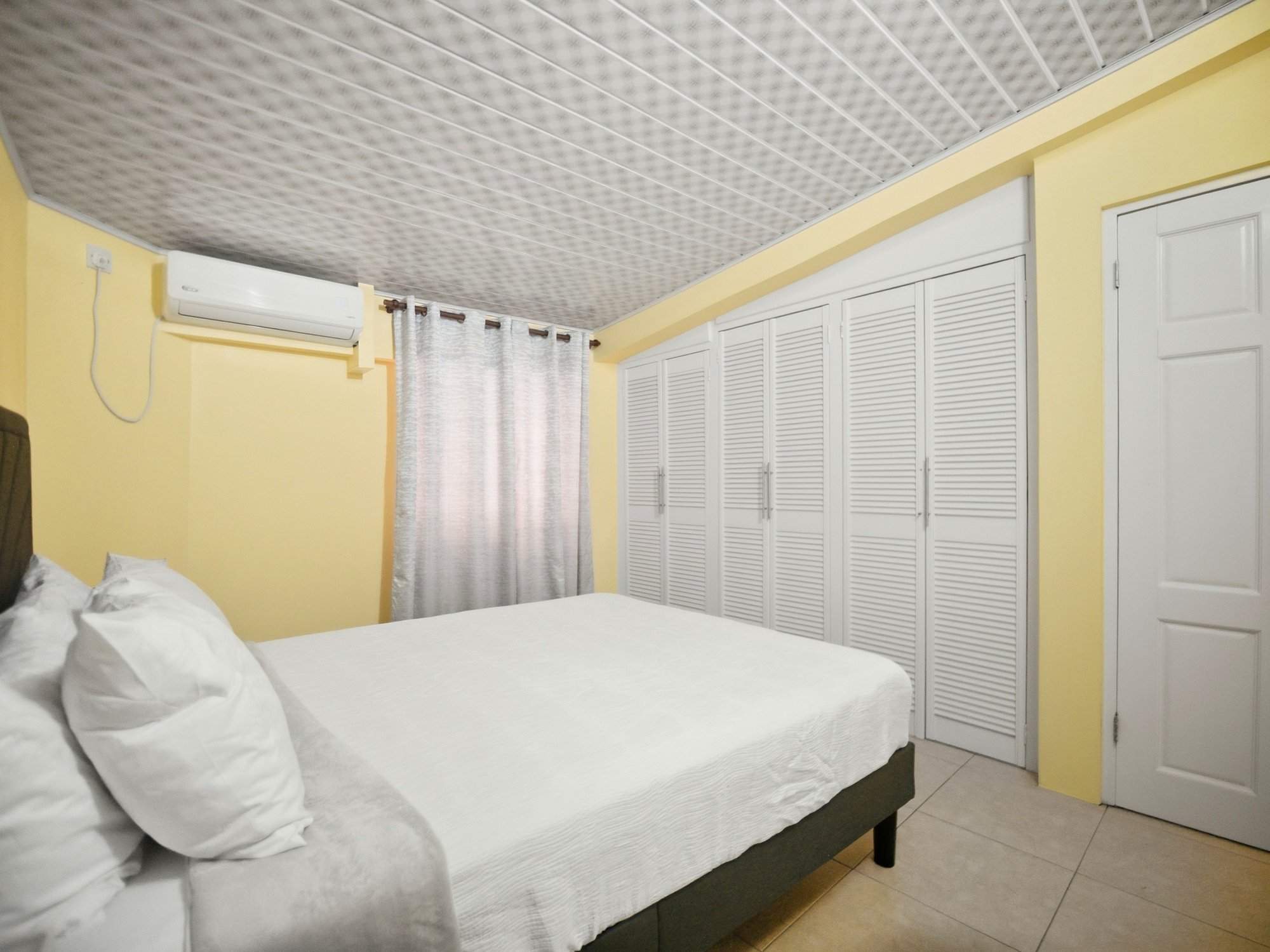 One Bedroom unit bedroom with queen bed and built-in closets