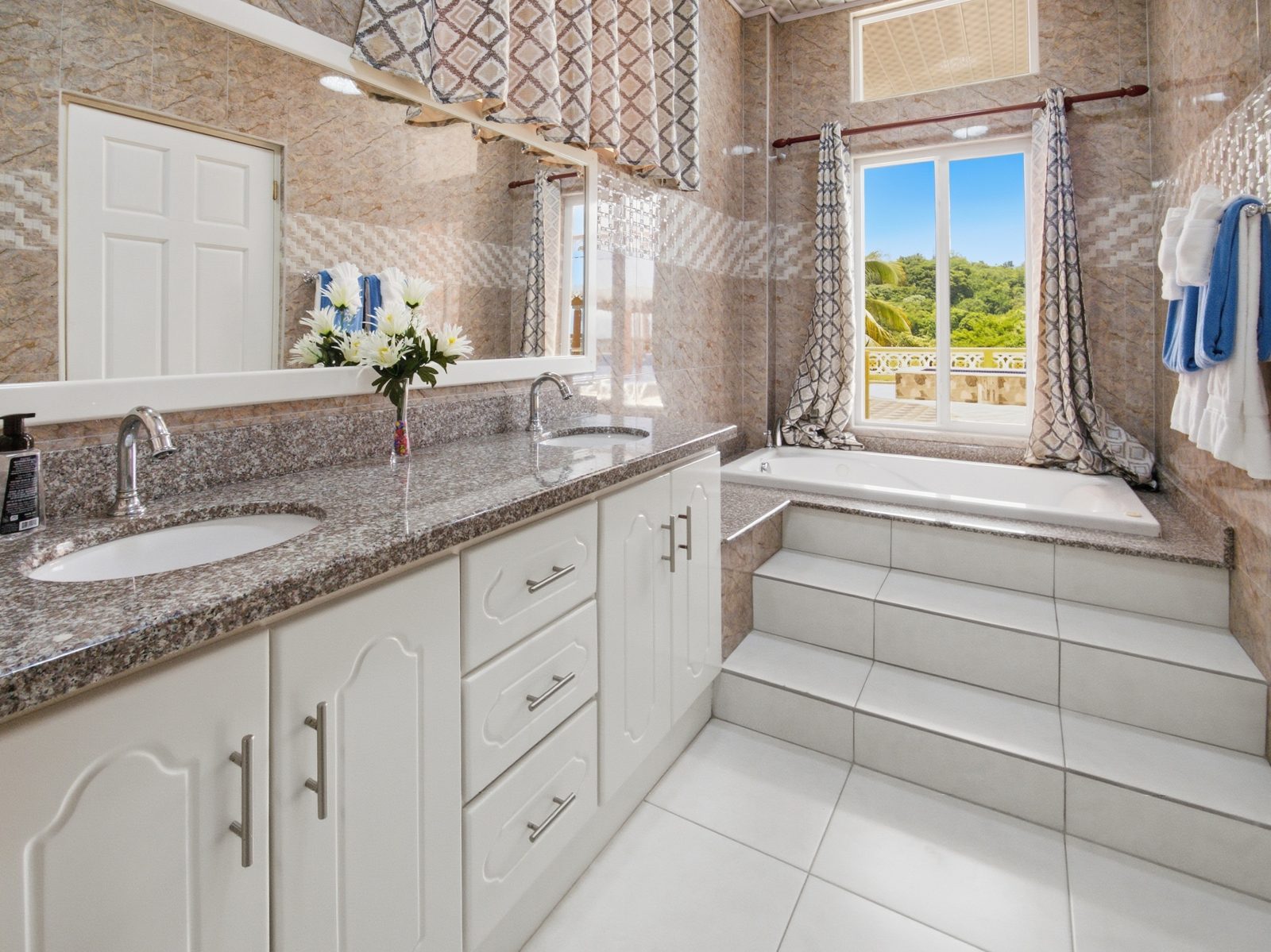 Poolside Suite bathroom with jetted tub and garden view